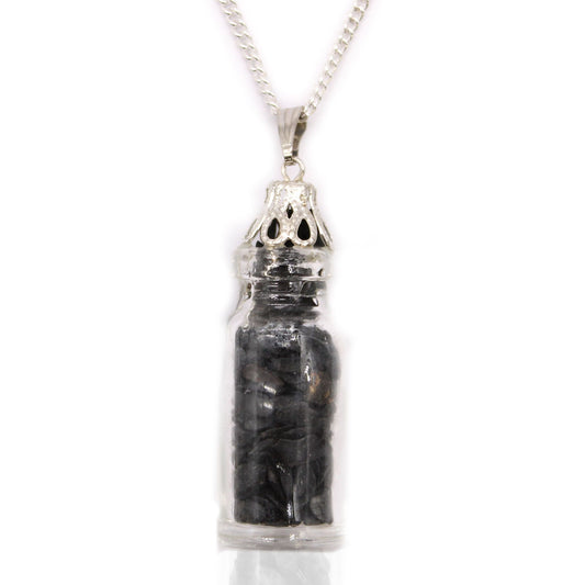 Delicate glass bottle pendant filled with small black onyx gemstones on a silver-coloured chain.