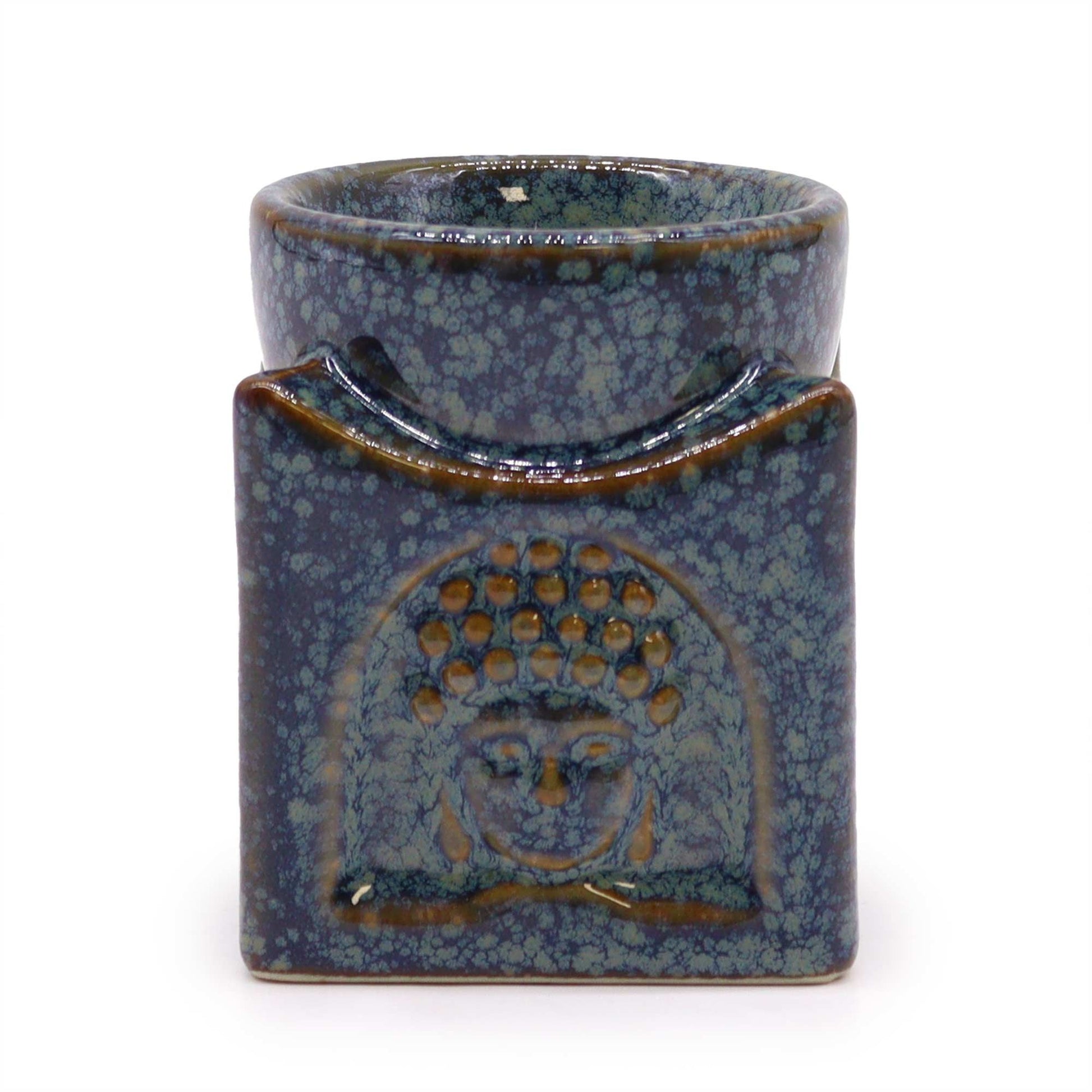 Square ceramic oil burner in dusty blue featuring a peaceful Buddha face design on the front.