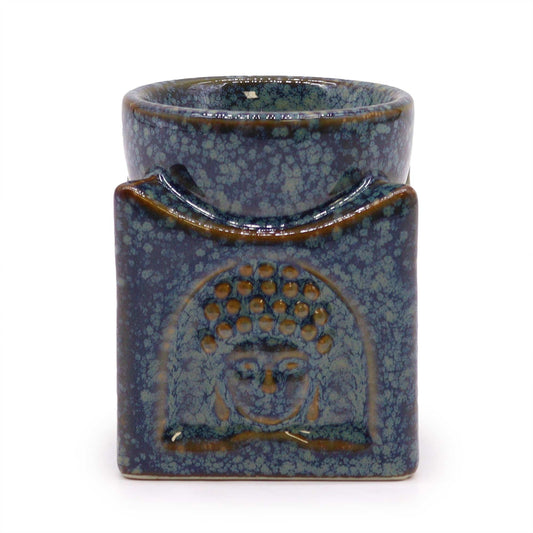 Square ceramic oil burner in dusty blue featuring a peaceful Buddha face design on the front.
