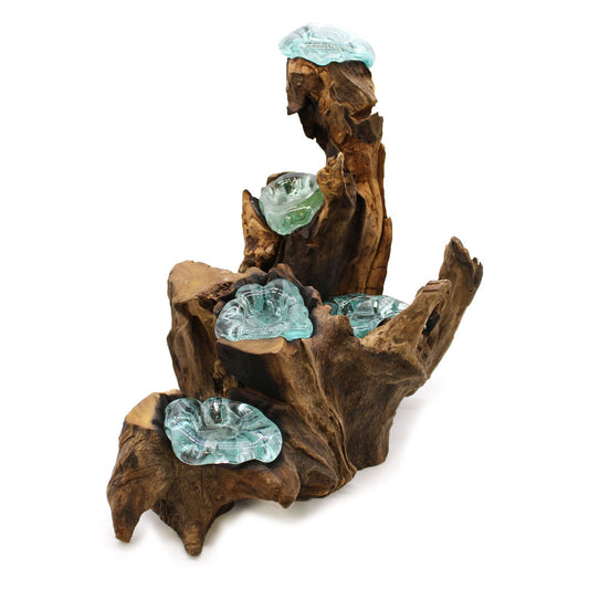 Five hand-blown molten glass candle holders slumped over a natural gamal wood root base.