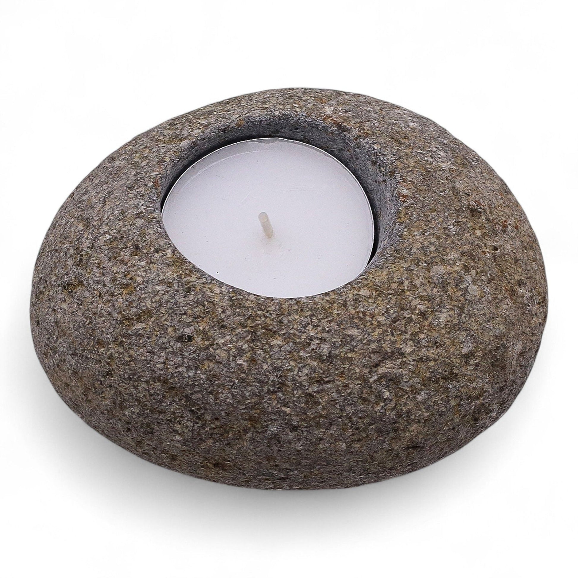Hand-carved natural grey riverstone tea light candle holder with a raw organic texture and smooth central well.