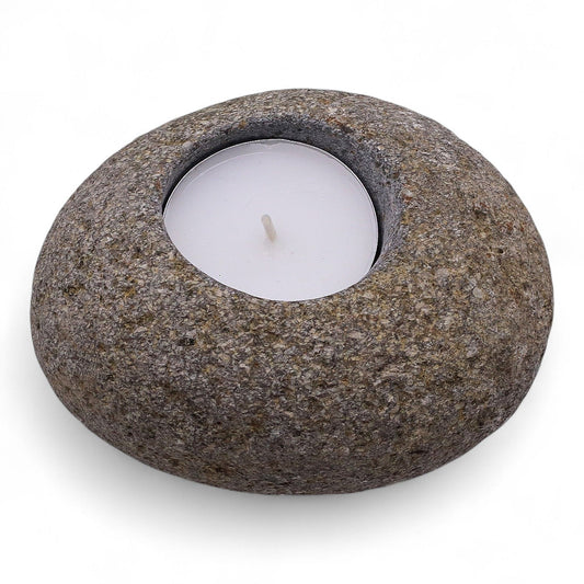 Hand-carved natural grey riverstone tea light candle holder with a raw organic texture and smooth central well.