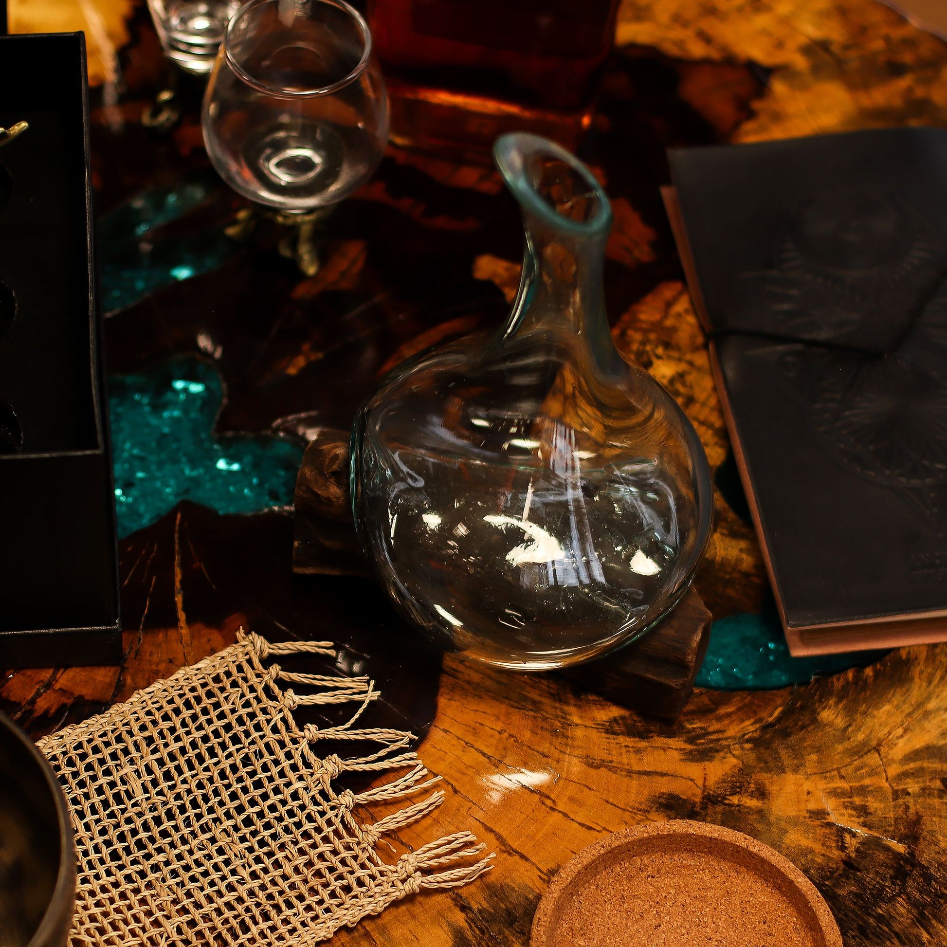 Miniature hand-blown molten glass decanter slumped over a natural reclaimed wood base.