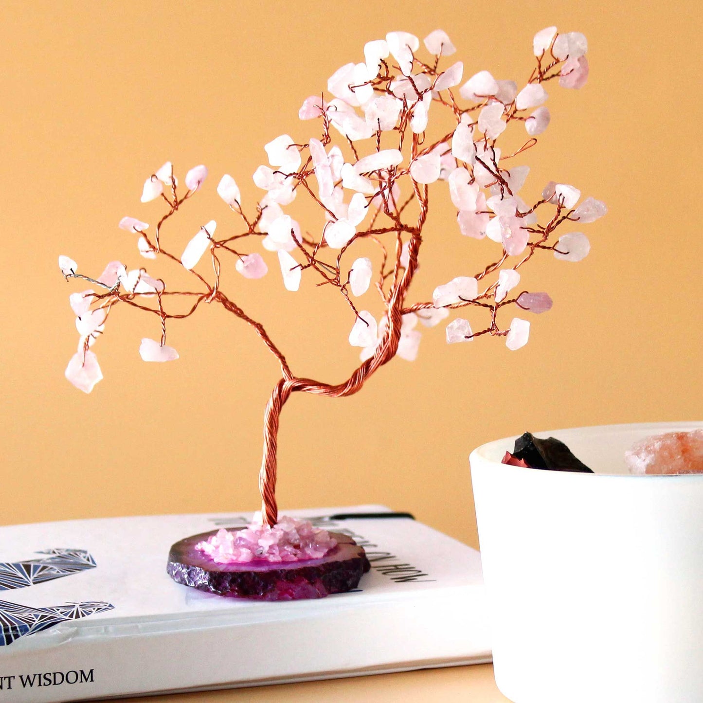 Large gemstone tree featuring delicate rose quartz leaves and a polished pink agate base with twisted wire branches.