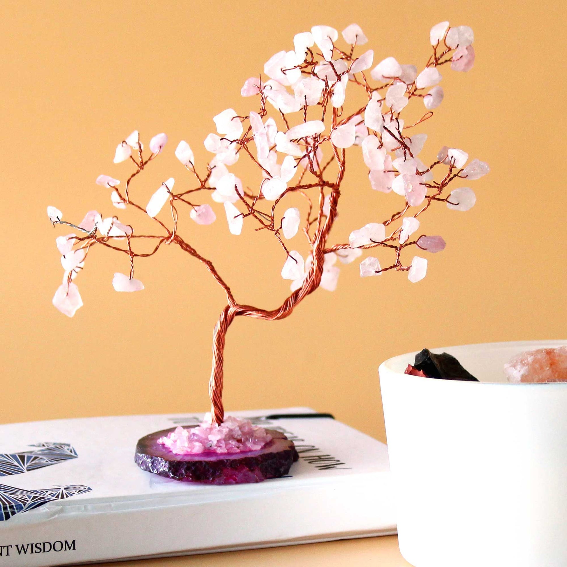 Large gemstone tree featuring delicate rose quartz leaves and a polished pink agate base with twisted wire branches.