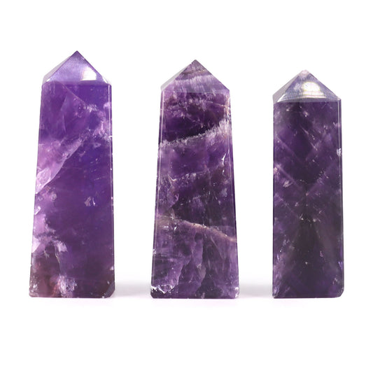Small polished purple African Amethyst gemstone obelisk point with natural crystalline patterns.
