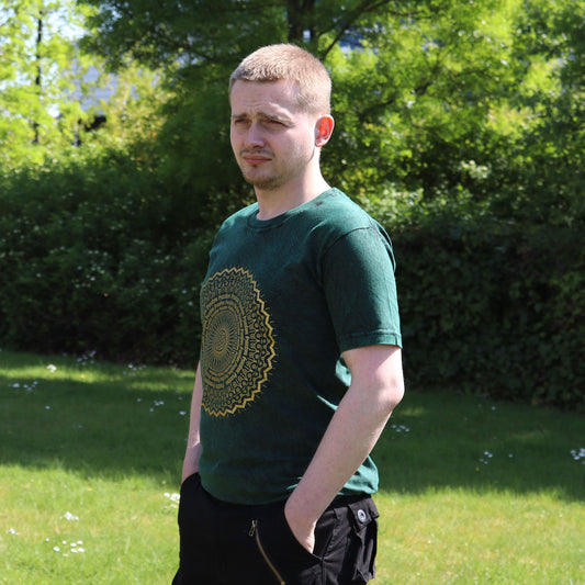 Green stonewashed t-shirt featuring a large white circular mandala print on the front.