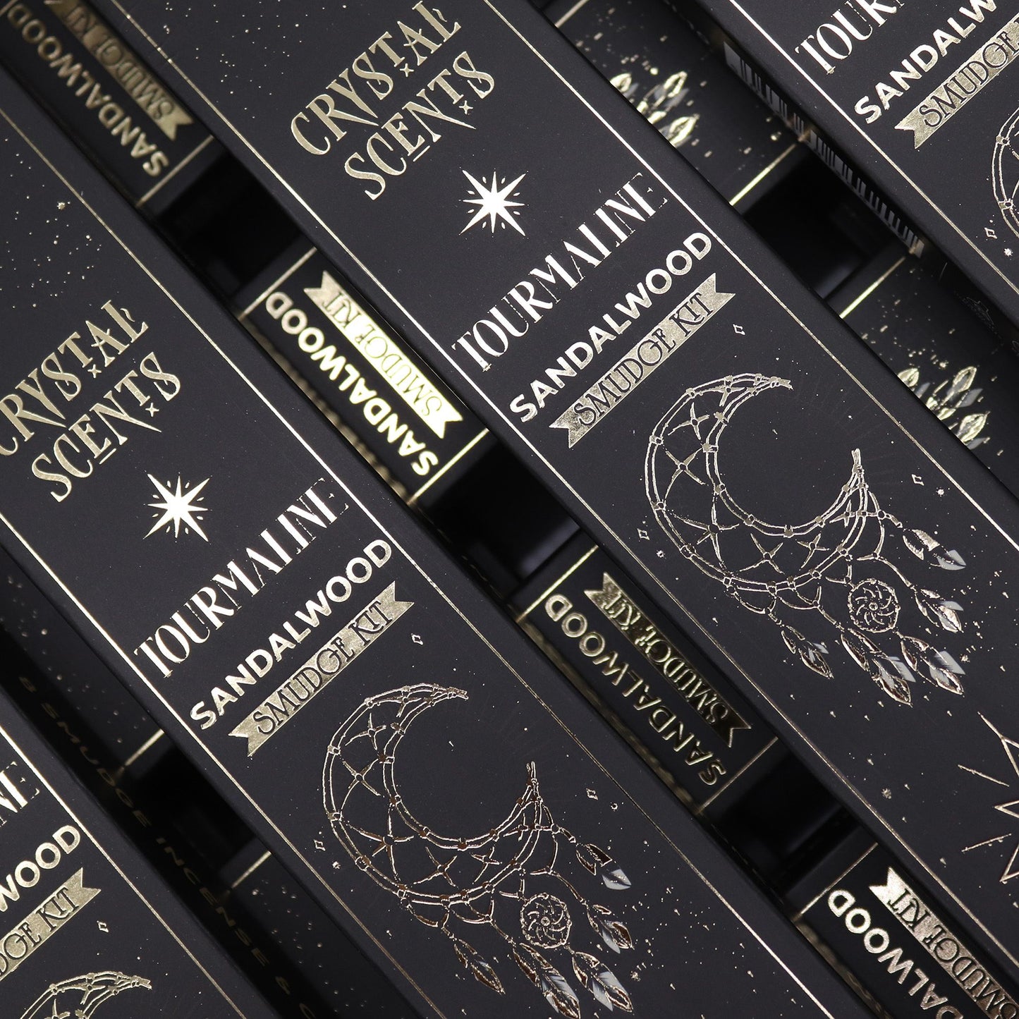 Handcrafted smudge-style incense sticks in a decorative box featuring natural black tourmaline gemstone chips.