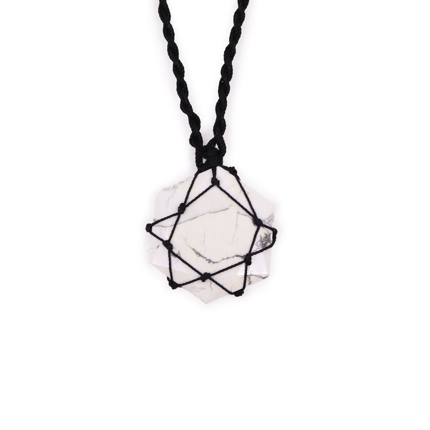 Hexagonal white howlite gemstone pendant with grey veining, featuring an intricate silver-style laced metal wrap.