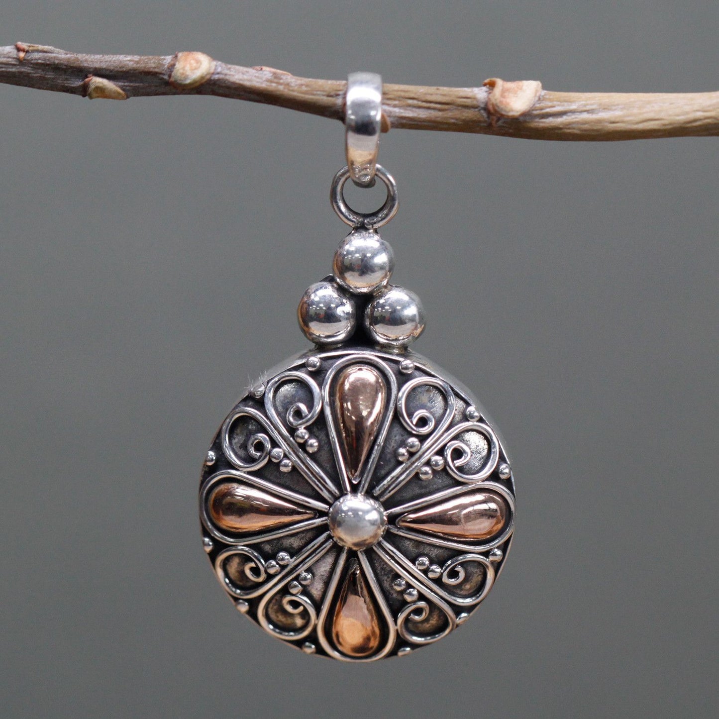 Elegant mixed metal pendant featuring a classic round design in polished silver and gold finishes.