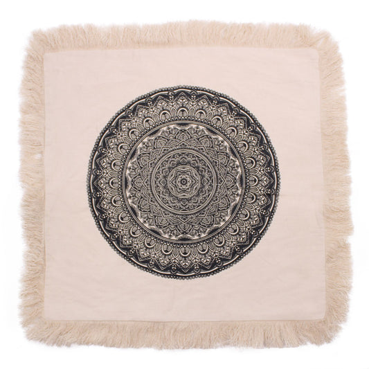 Large square black cushion cover featuring an intricate white traditional mandala pattern.
