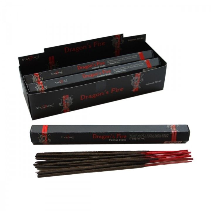 A pack of incense sticks with a mystical dragon design on the packaging, releasing a thin trail of fragrant smoke.