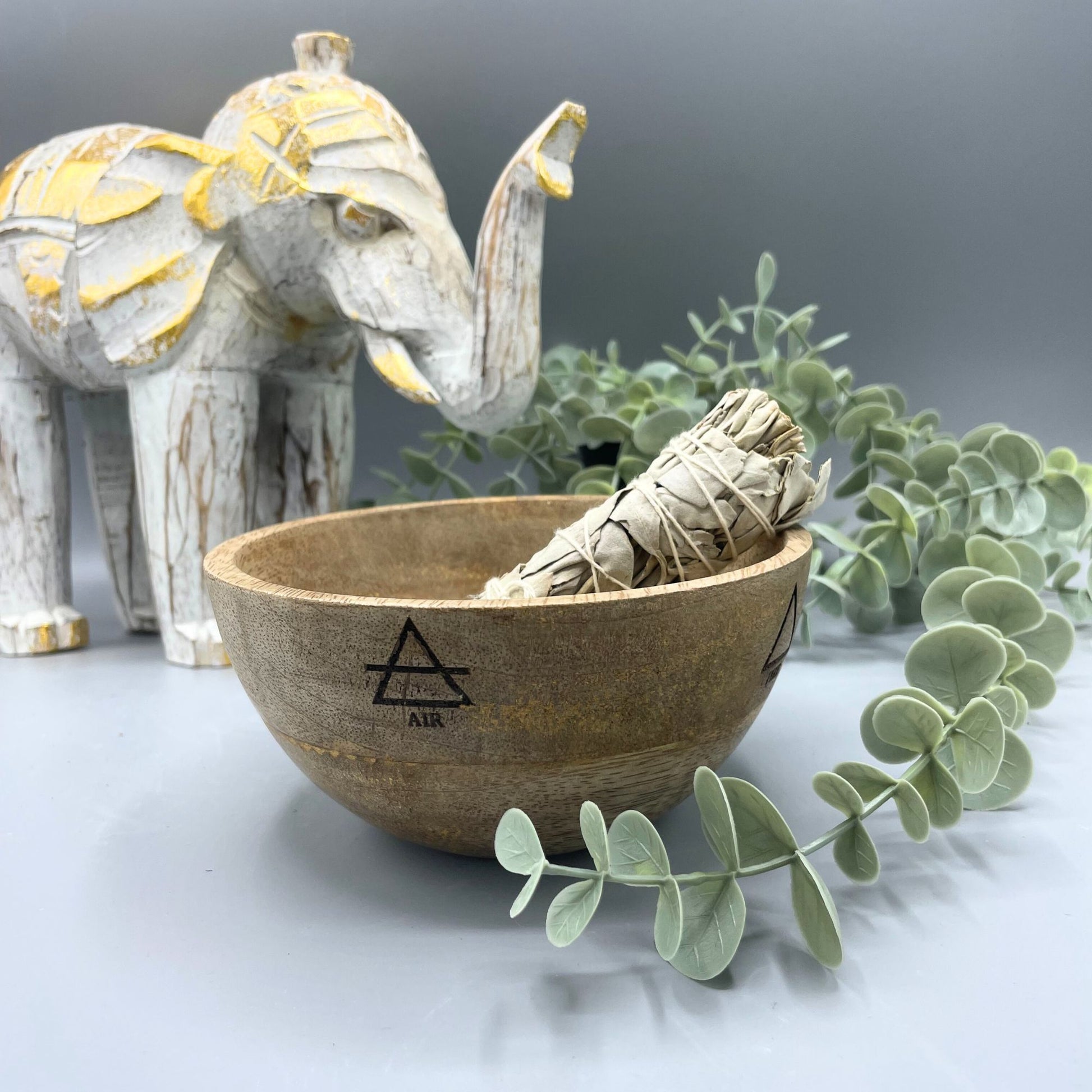 Handcrafted wooden ritual bowl with Four Elements engraving, designed for smudging and spiritual offerings.