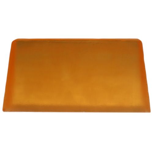 A hand-cut slice of artisan aromatherapy soap with a creamy texture and vibrant yellow citrus hue.