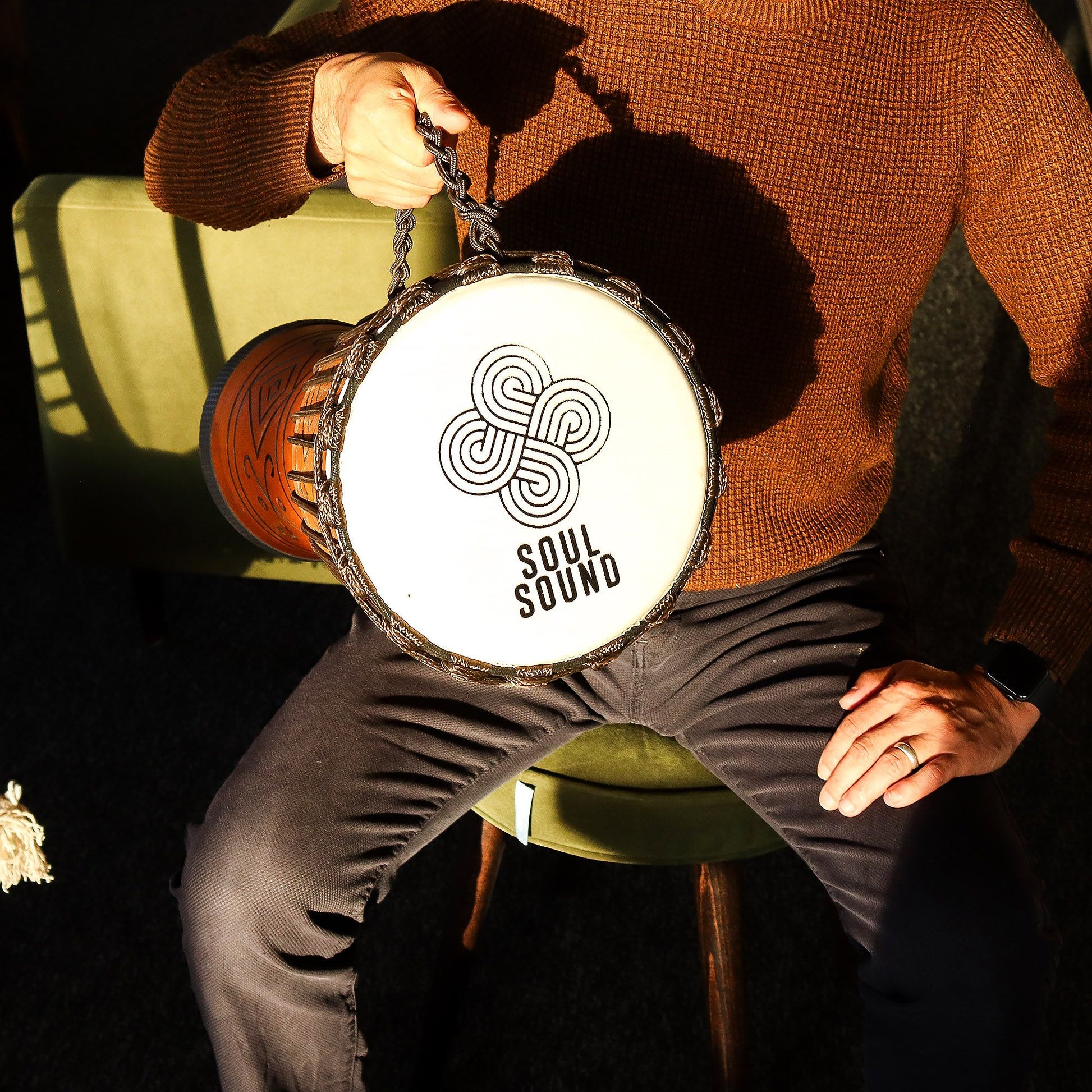 Large professional djembe drum with a natural wood finish and authentic goat skin head on a neutral background.