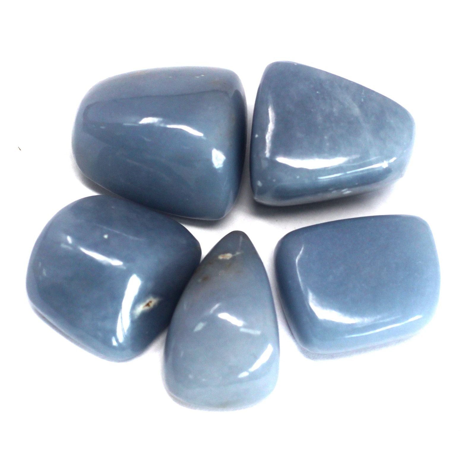 A smooth, polished pale blue Angelite tumble stone with a soft, matte-like finish.