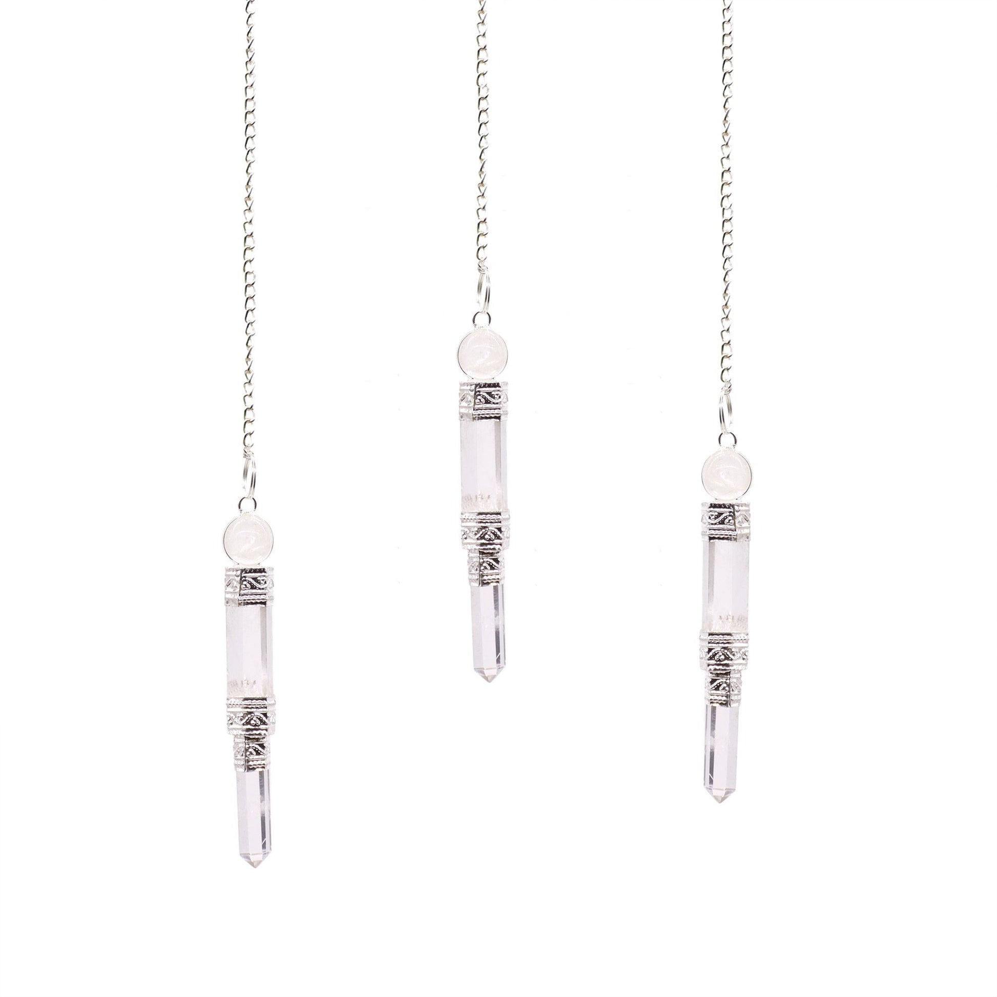 Clear rock quartz crystal pendulum with a silver chain and small gemstone bead at the top.