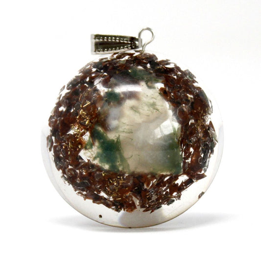 Dome shaped orgonite pendant featuring gemstone chips, copper coils, and metal filings for spiritual healing.