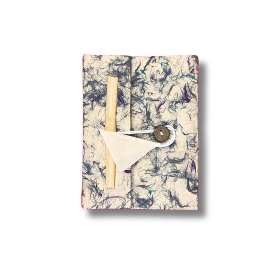 Handmade Lokta paper notebook with a soft textured blue cotton flecked cover and natural deckled edges.