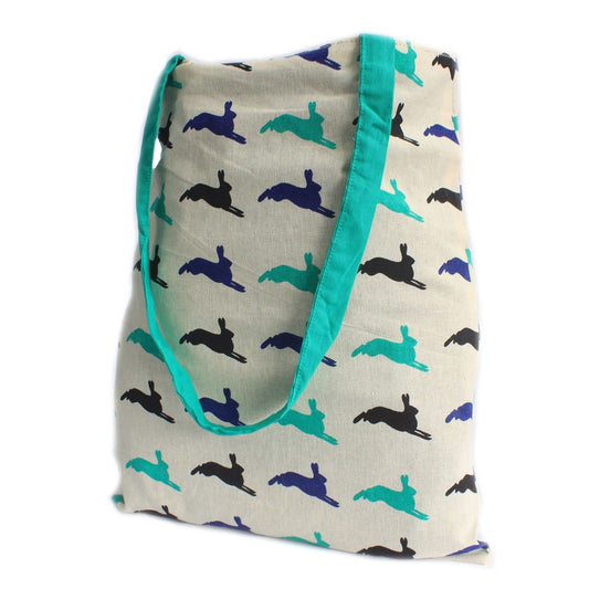 Large green reversible tote bag featuring a white block print hare design and durable fabric straps.