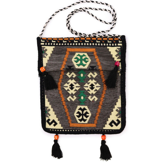 Handcrafted pale grey kilim messenger bag with intricate geometric woven patterns and a long shoulder strap.