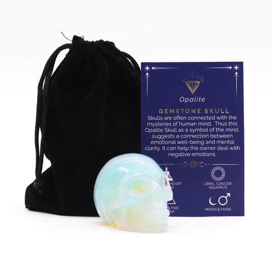 Large iridescent opalite gemstone skull with a smooth polished finish and subtle blue and gold highlights.