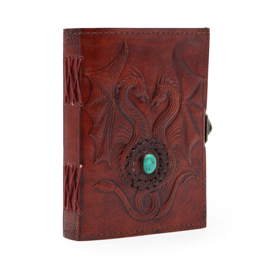 Antique grey leather notebook with an embossed two dragons design and hand-stitched edges on a plain background.