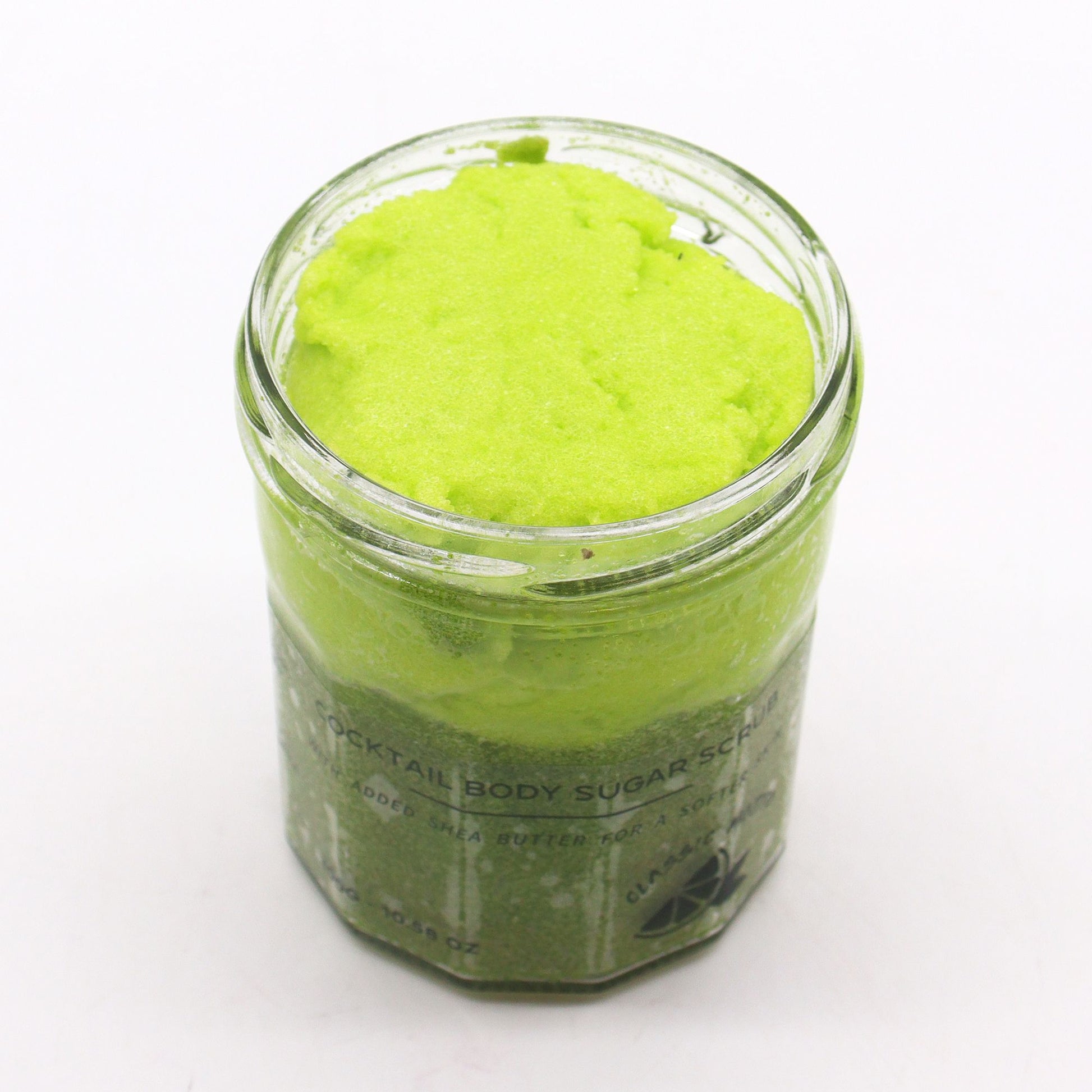 Tub of zesty lime and mint scented sugar body scrub for exfoliating skincare rituals.