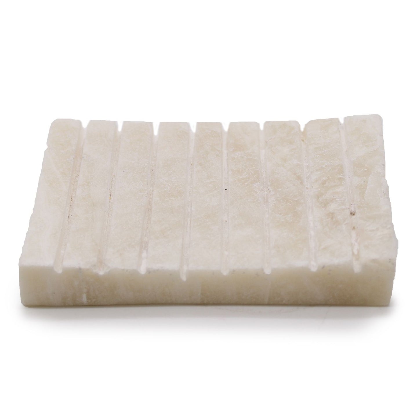 Elegant white onyx soap dish with a ridged surface and natural stone marbling.