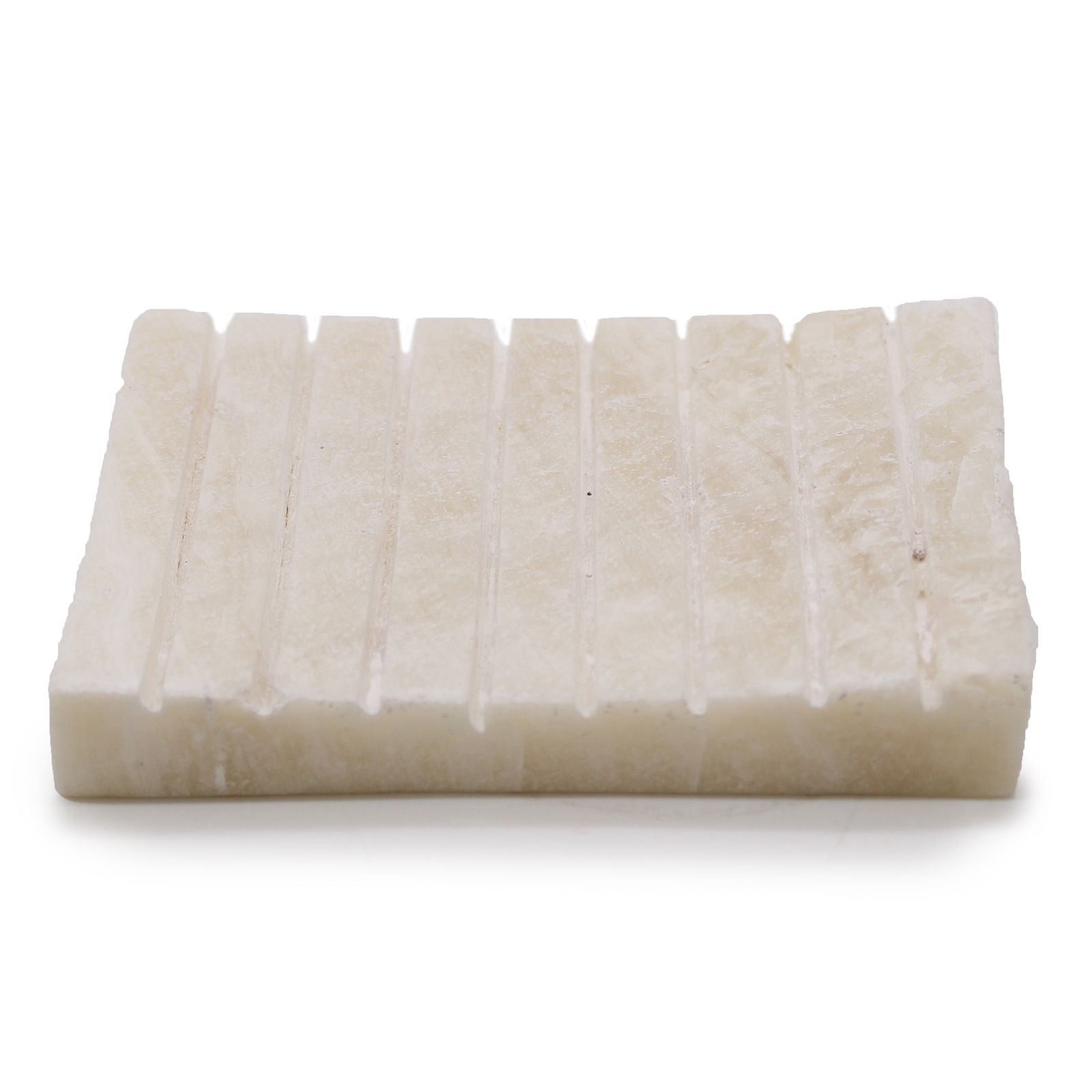 Elegant white onyx soap dish with a ridged surface and natural stone marbling.