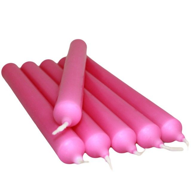 A tall, elegant fuchsia pink dinner candle with a smooth finish.