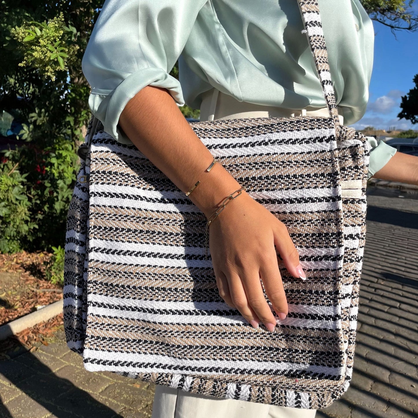 Soft fabric laptop bag featuring a bohemian Banjar pattern in soft cream and grey with a padded interior.
