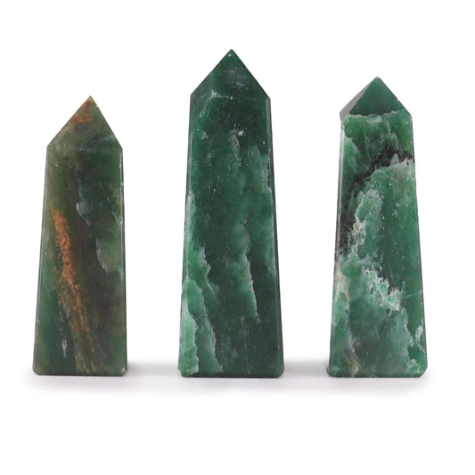 A small, polished green Indian Jade gemstone obelisk point standing upright on a neutral surface.