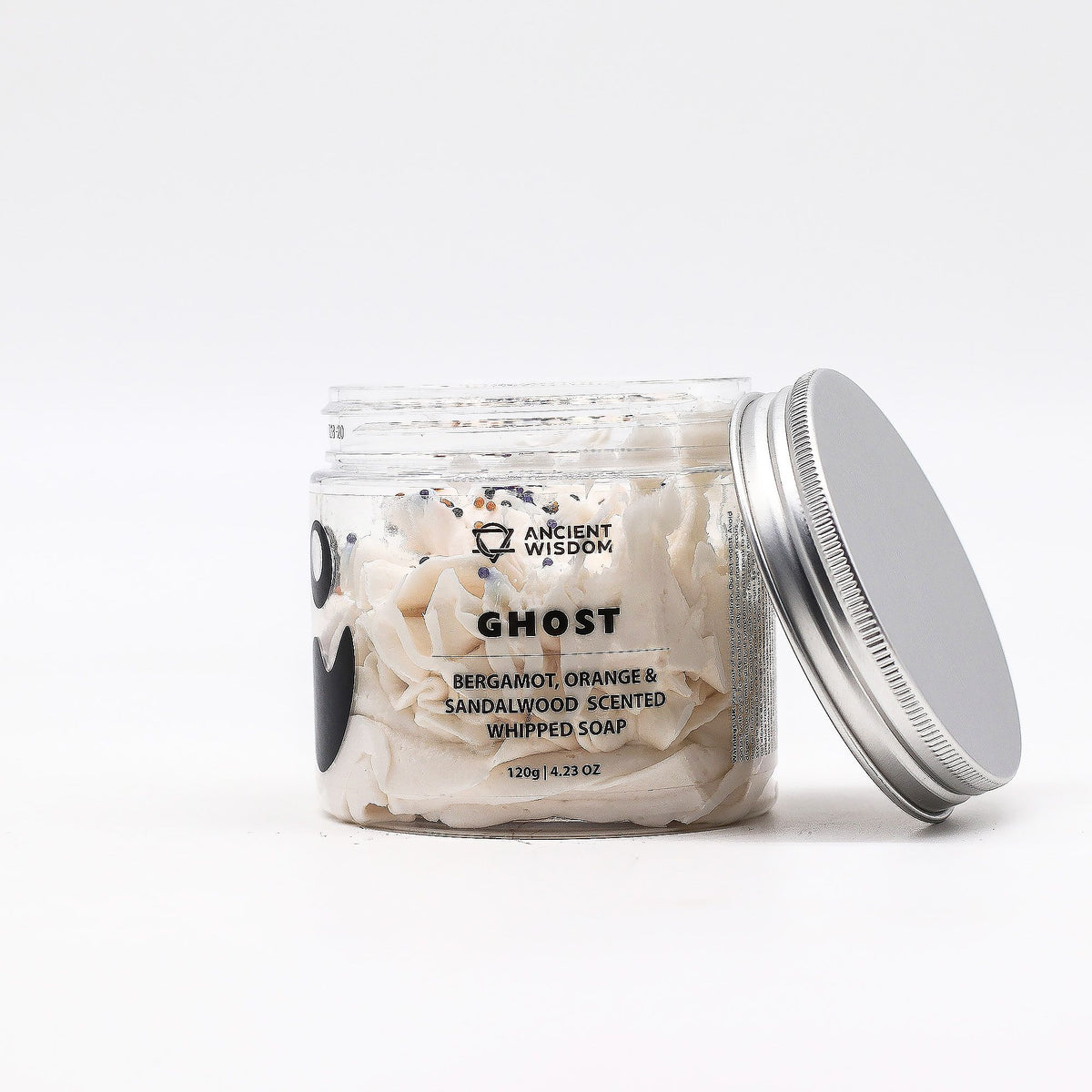 Light and airy white whipped soap in a clear jar with a fluffy mousse texture and smooth frothy surface.