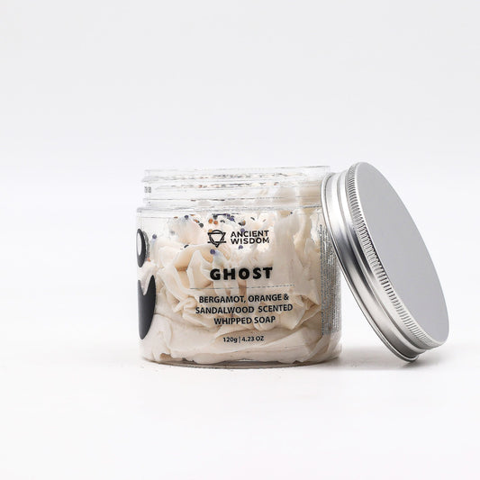 Light and airy white whipped soap in a clear jar with a fluffy mousse texture and smooth frothy surface.