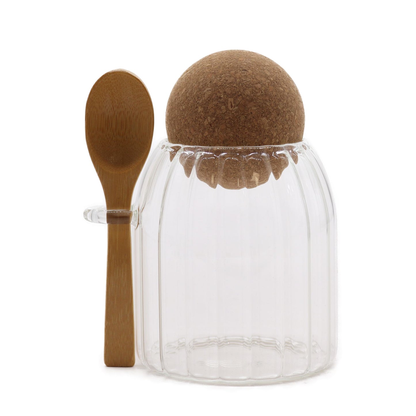 Small clear ribbed glass storage jar with a natural bamboo lid and a small wooden spoon held in a side loop.