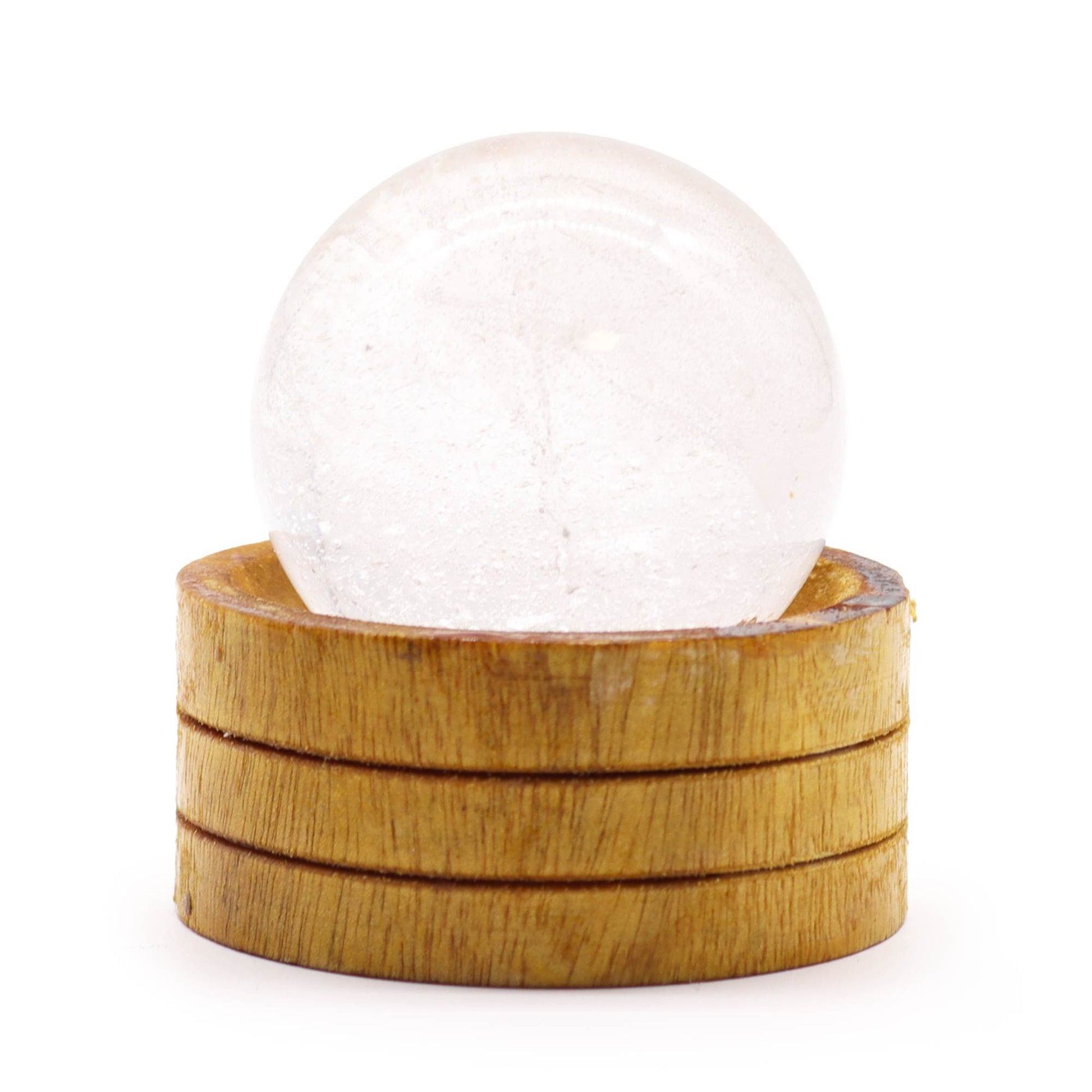 A polished 50mm clear quartz crystal sphere resting on a minimalist wooden display stand.