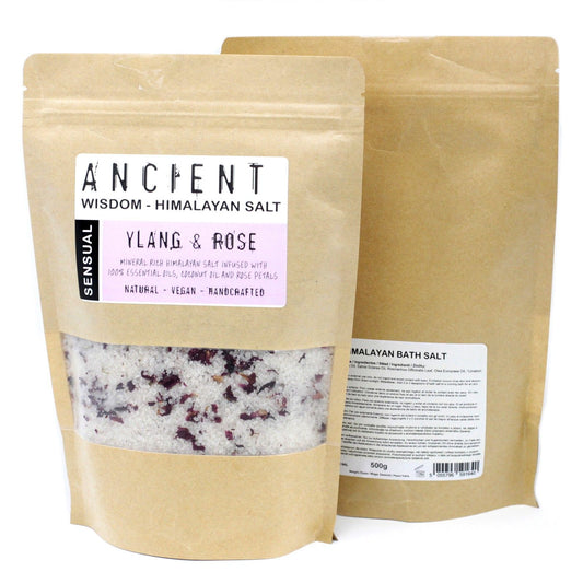 Pink Himalayan bath salts mixed with dried red rose petals and infused with essential oils in a glass jar.