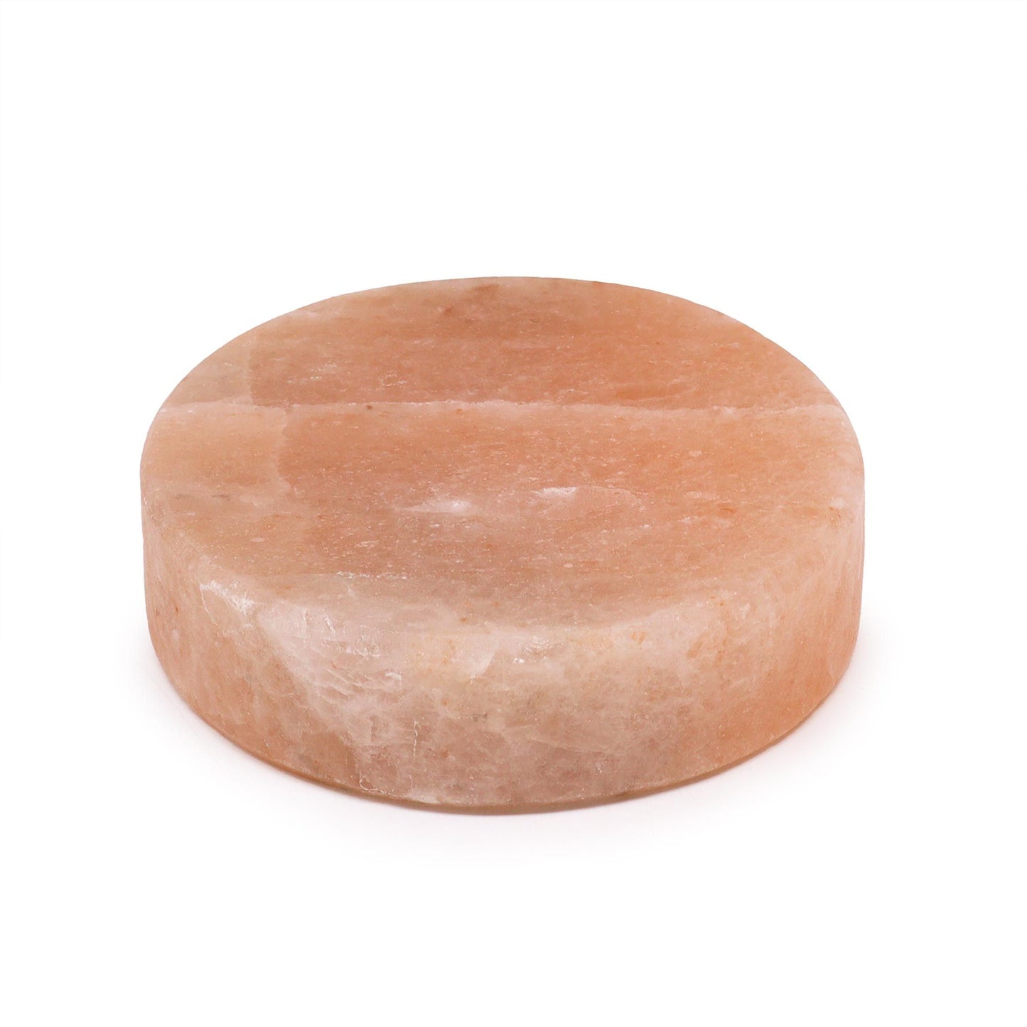 Large round pink Himalayan salt block for cooking and serving on a plain background.
