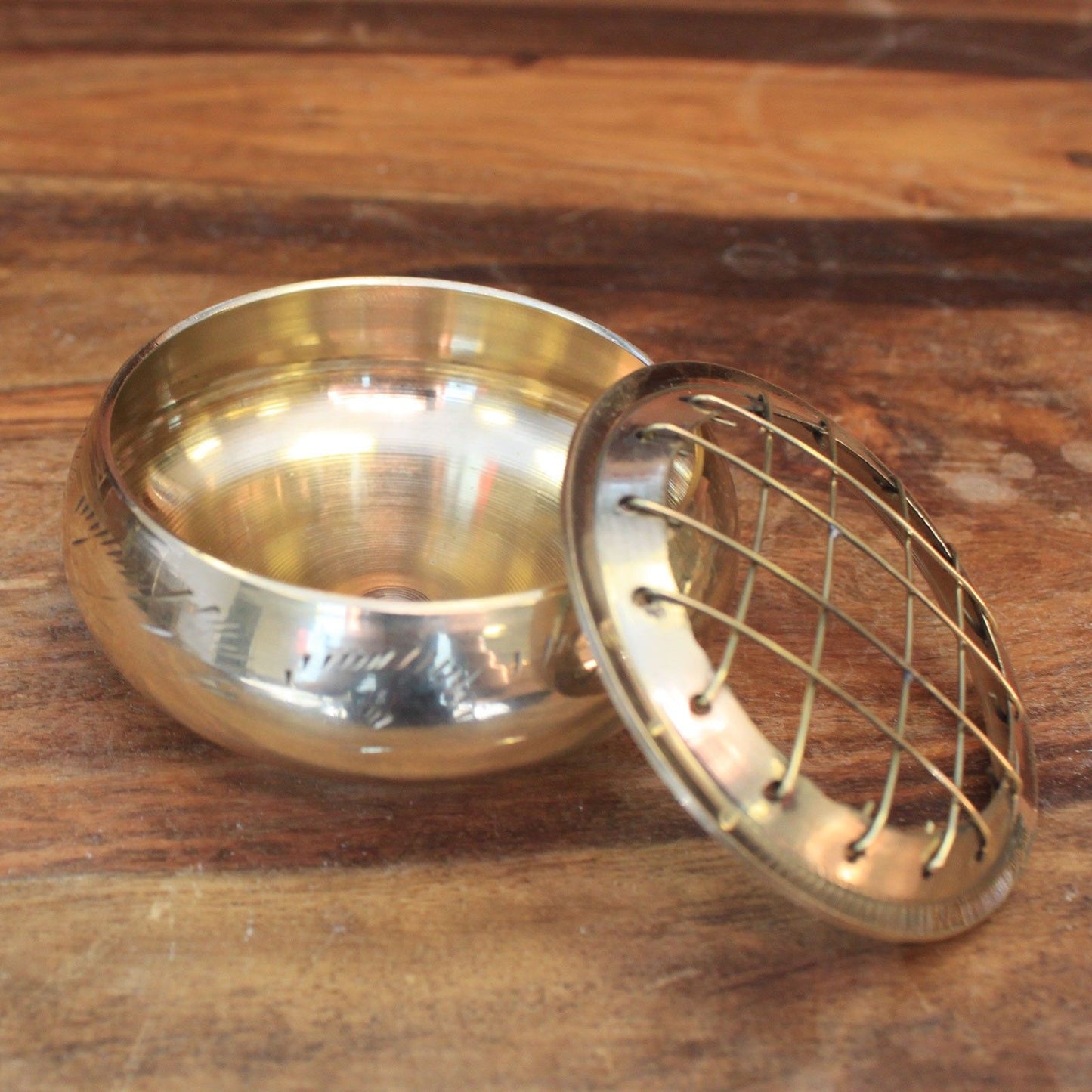 Compact polished brass incense jar with a decorative removable grid lid for burning charcoal and resins.