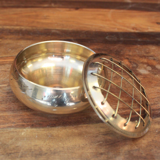Compact polished brass incense jar with a decorative removable grid lid for burning charcoal and resins.