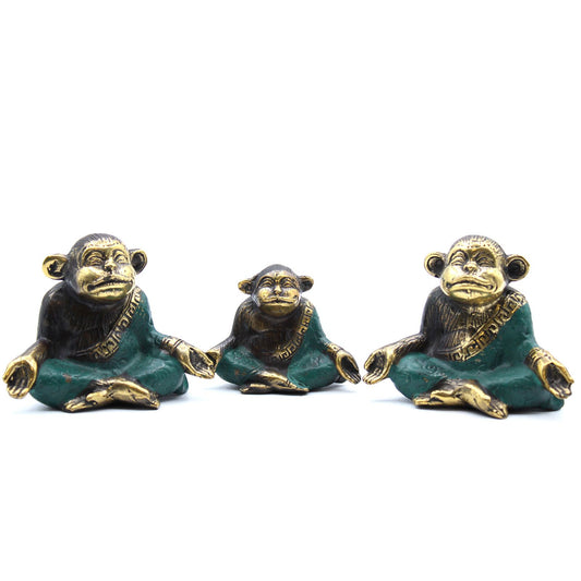 Set of three polished brass monkeys in various yoga poses, showcasing detailed craftsmanship and a serene aesthetic.