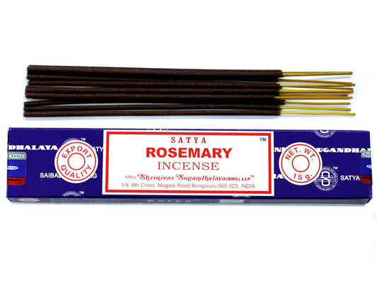 Hand-rolled rosemary incense sticks in a blue box on a wooden surface with a soft glow.
