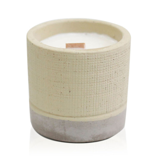 Minimalist grey concrete pot candle with a natural wooden wick and a raw, textured industrial finish.