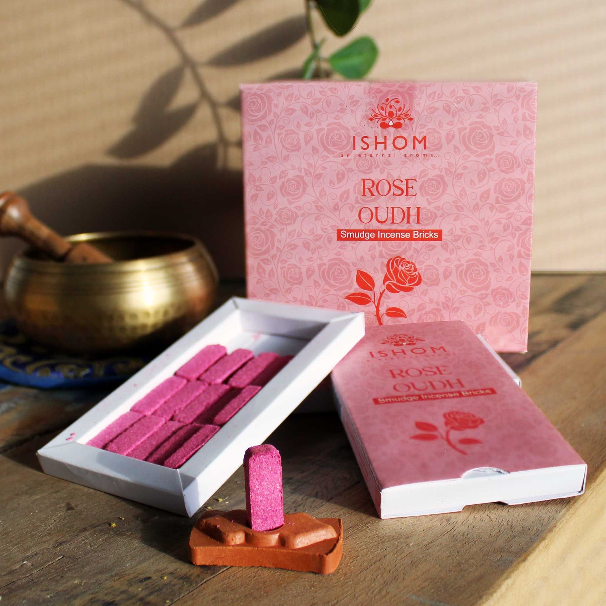 Pack of 15 natural rose wood incense smudge bricks arranged with a traditional terracotta incense burner.