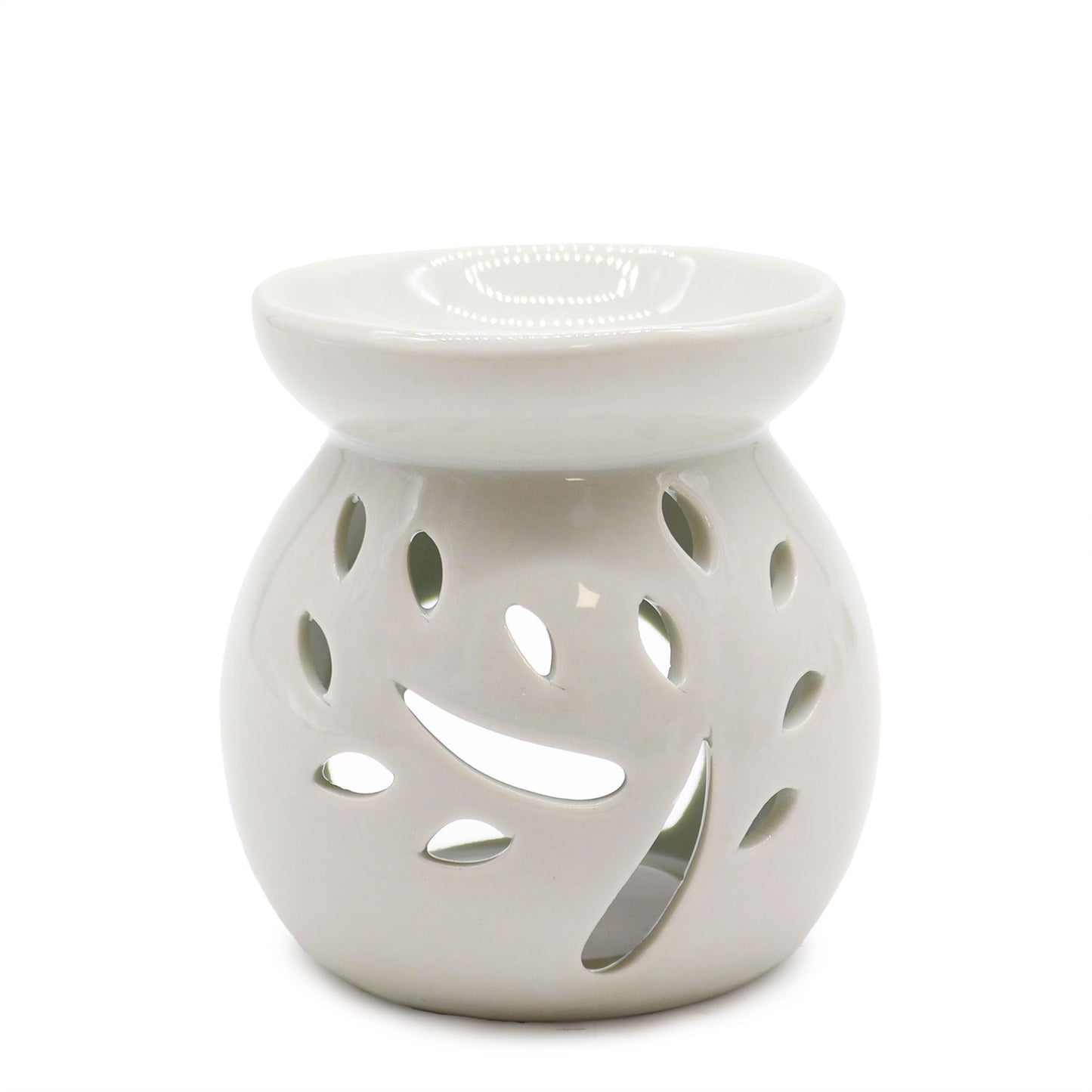 Minimalist white ceramic oil burner with a decorative tree-shaped cut-out pattern.