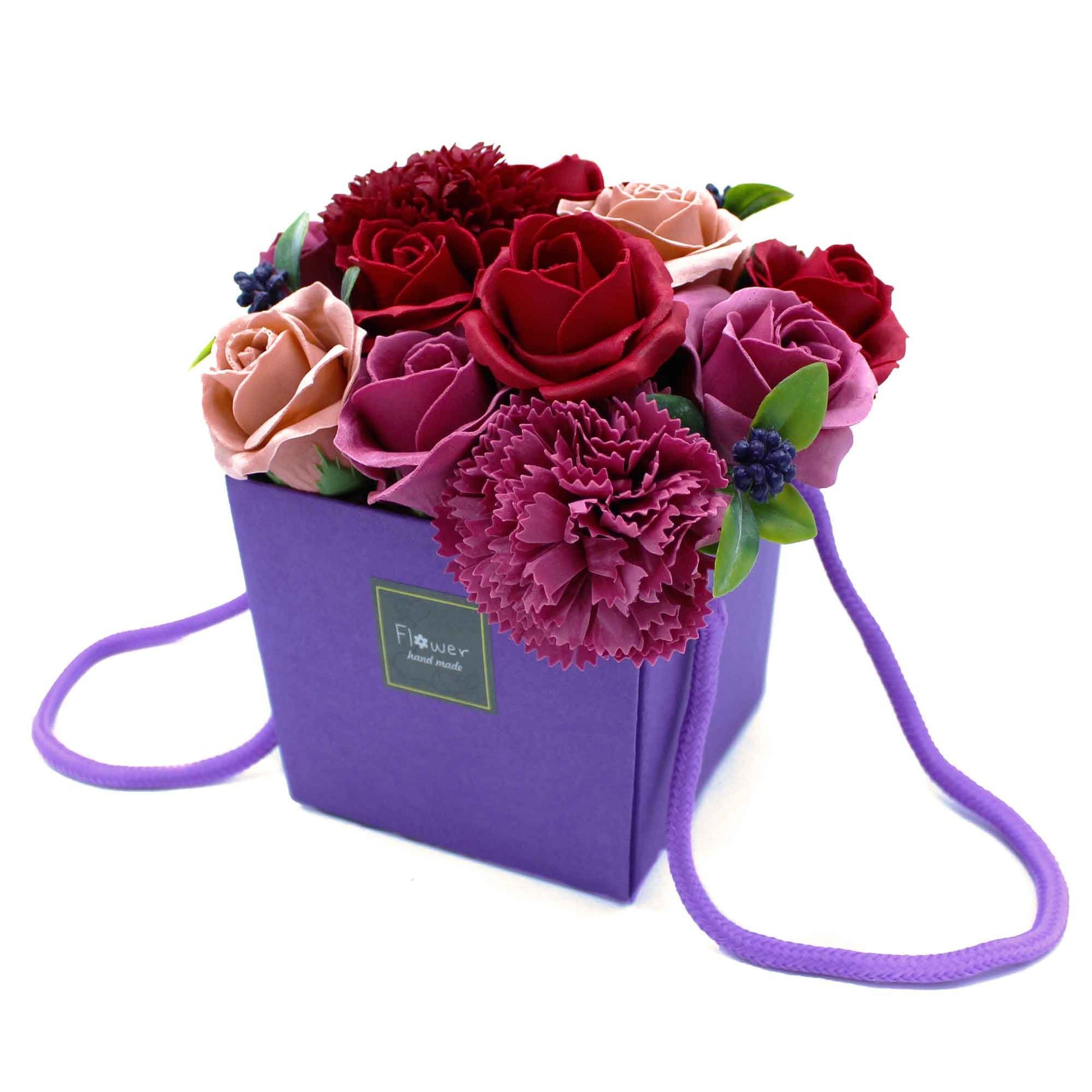 Artistic bouquet of realistic purple and white soap flowers arranged in a decorative gift box.