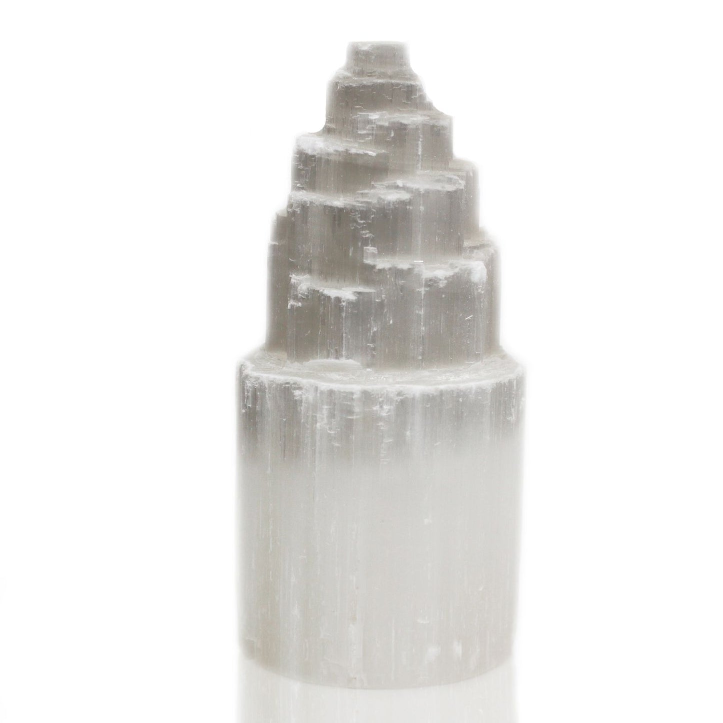 Tall white natural selenite crystal tower lamp with a textured, crystalline surface emitting a soft ethereal glow.