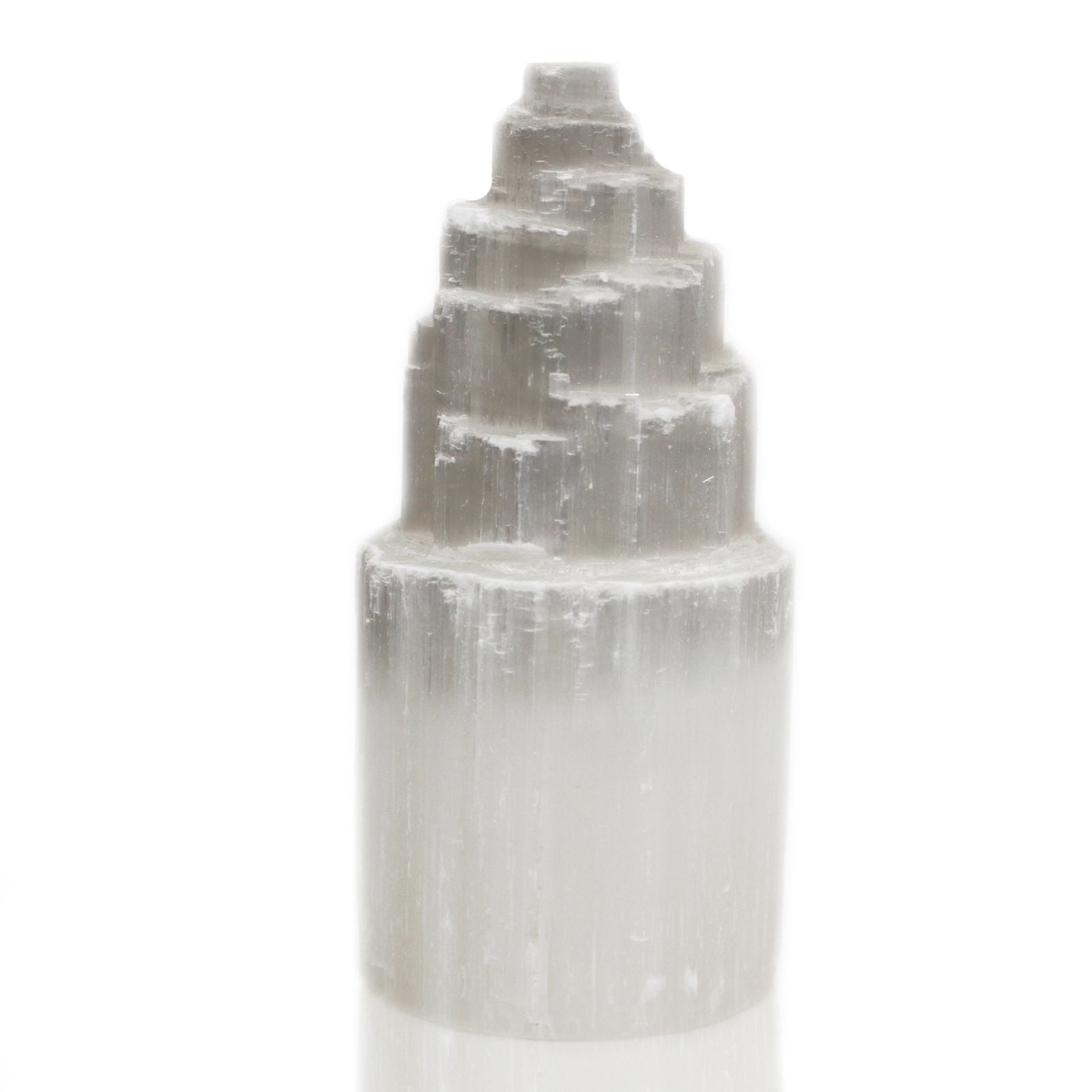 Tall white natural selenite crystal tower lamp with a textured, crystalline surface emitting a soft ethereal glow.