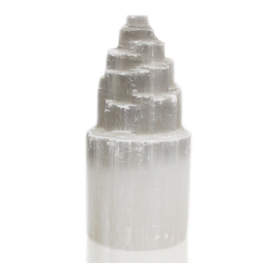 Tall white natural selenite crystal tower lamp with a textured, crystalline surface emitting a soft ethereal glow.